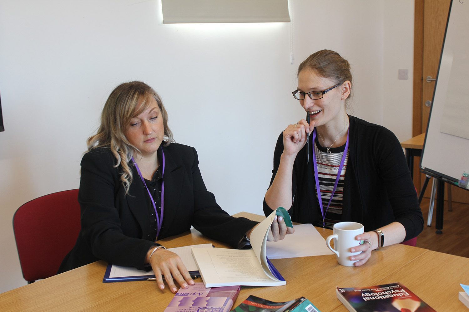 Two delegates conversing at a Therapy Expo.