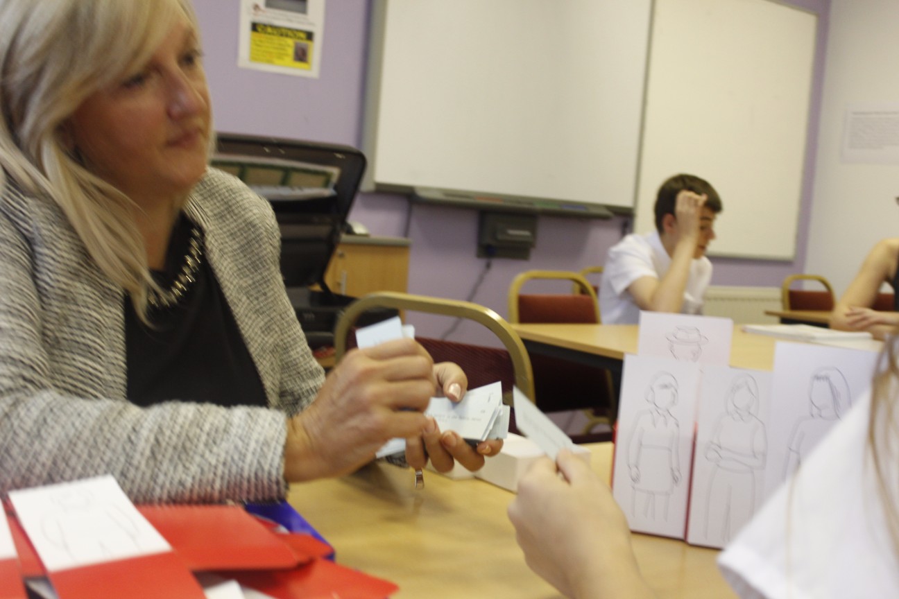 Dr. Alfrey holding cards.