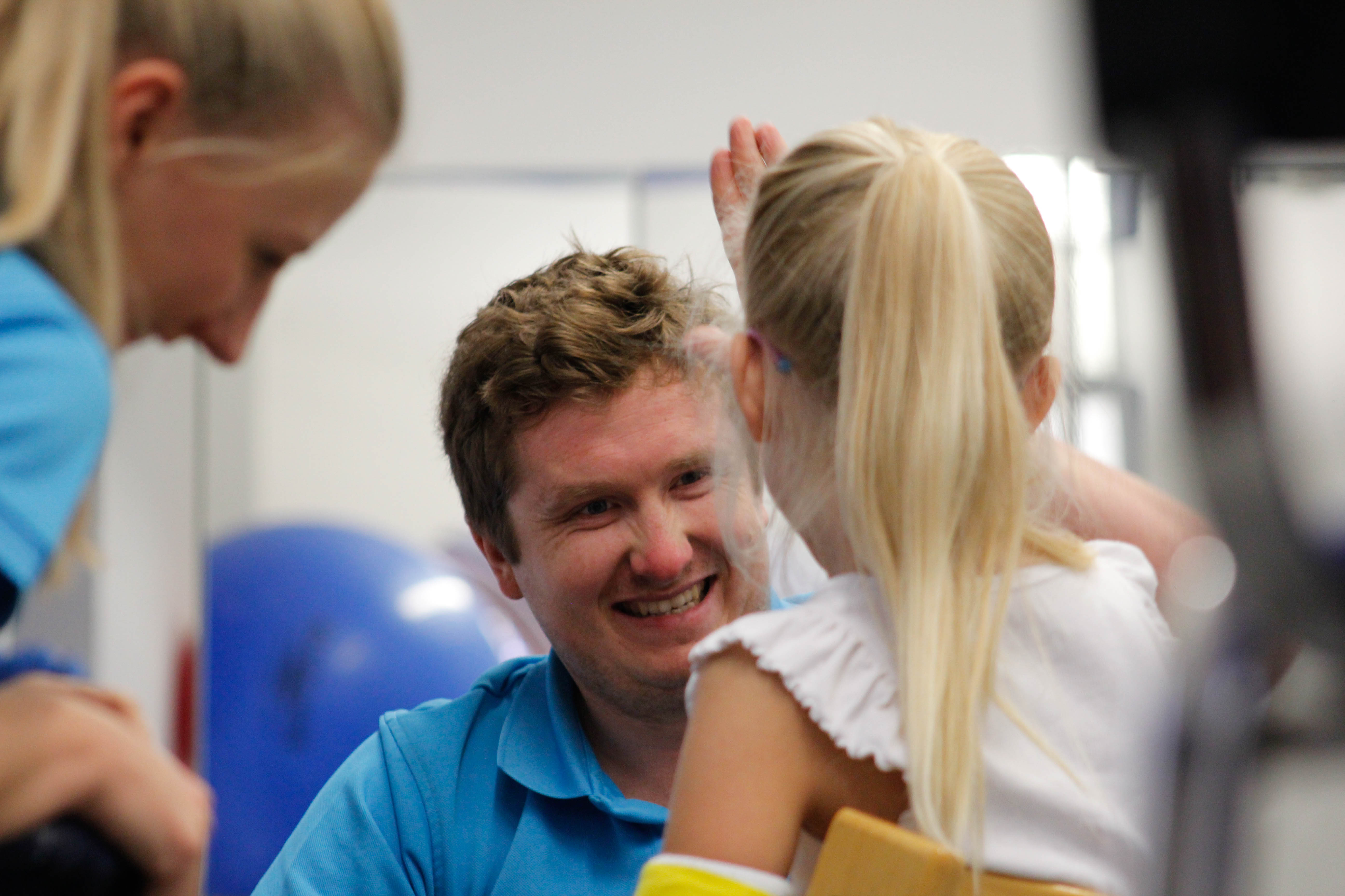 CIMT therapist smiling at small child.