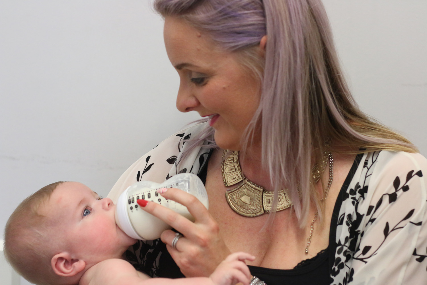 Woman feeding a baby.