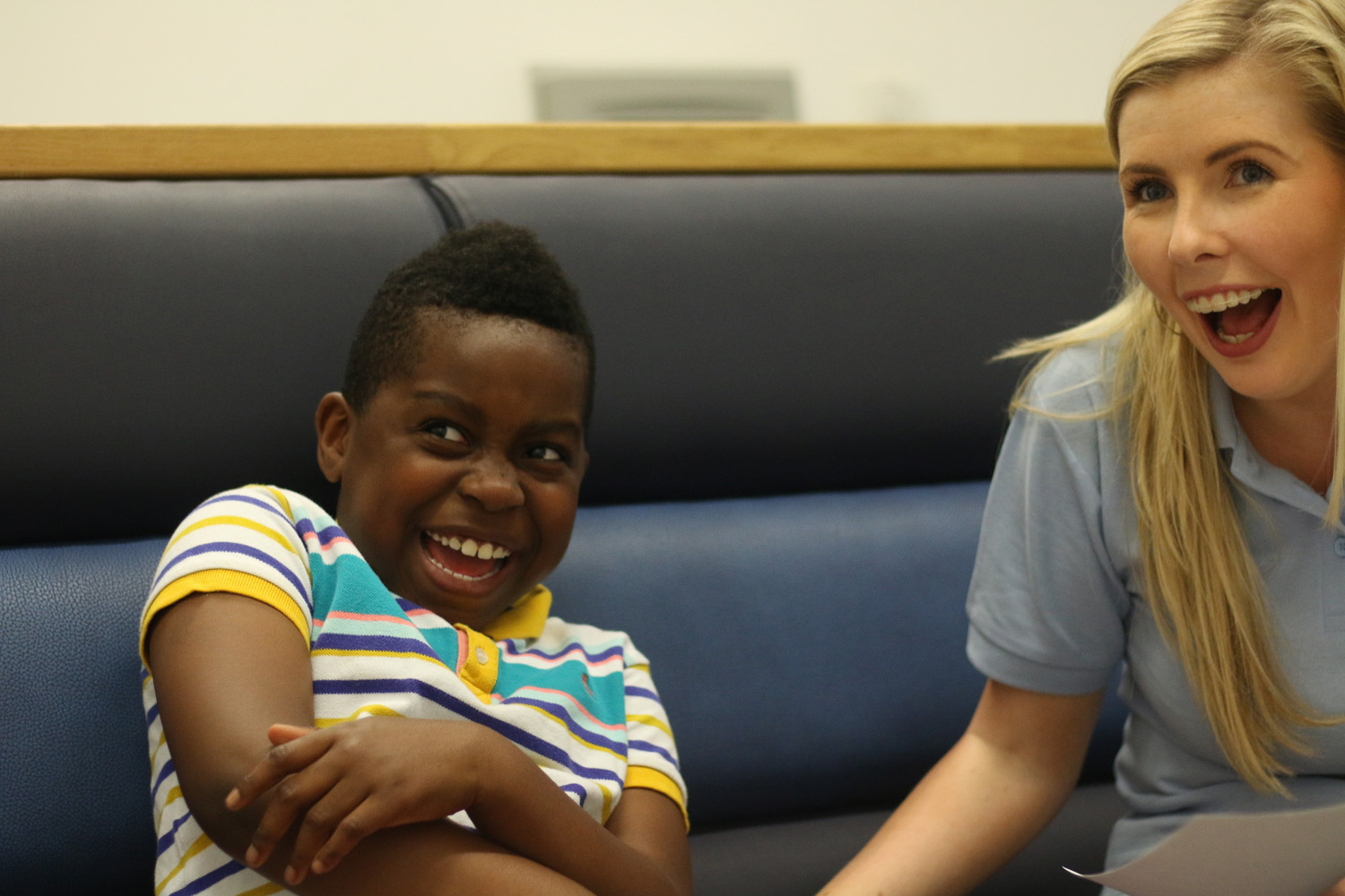 Kids Feeding Team specialist and smiling young boy.