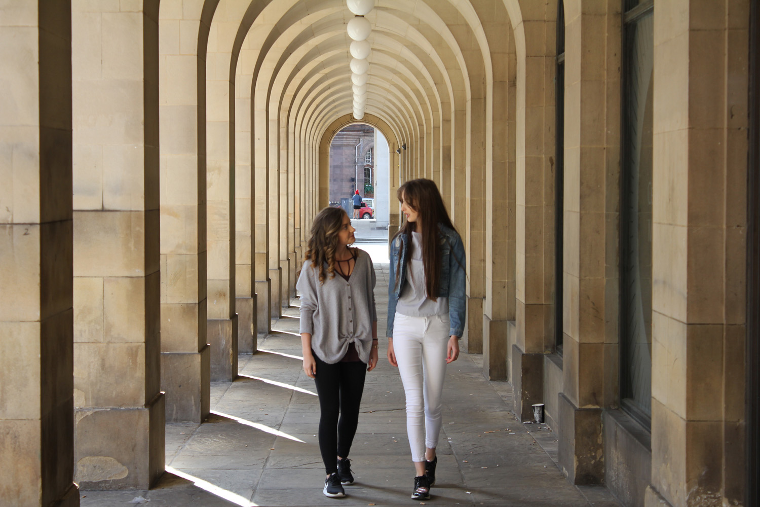 Two girls walking outside.