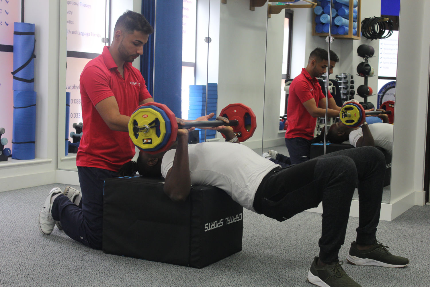 Orthotics therapist working with bench presser.