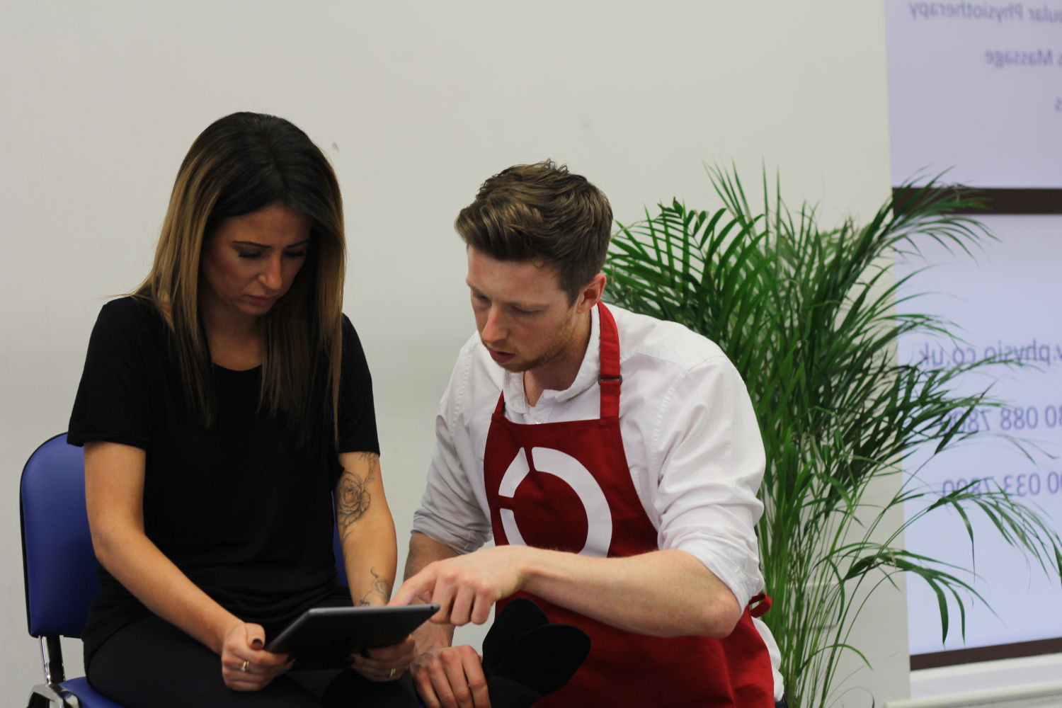 Patient and client looking at tablet.