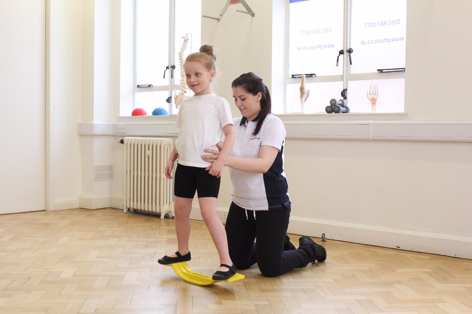 OT Kids specialist working with girl on balance boards.