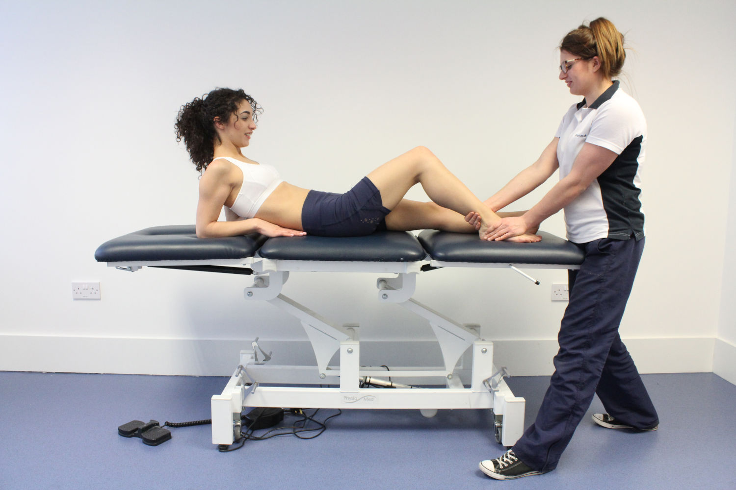 Patient laid on table with knee raised.