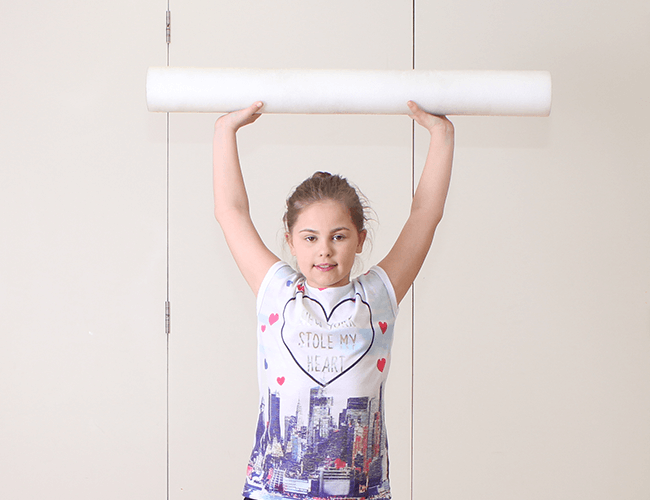 Youngster lifting foam roller.