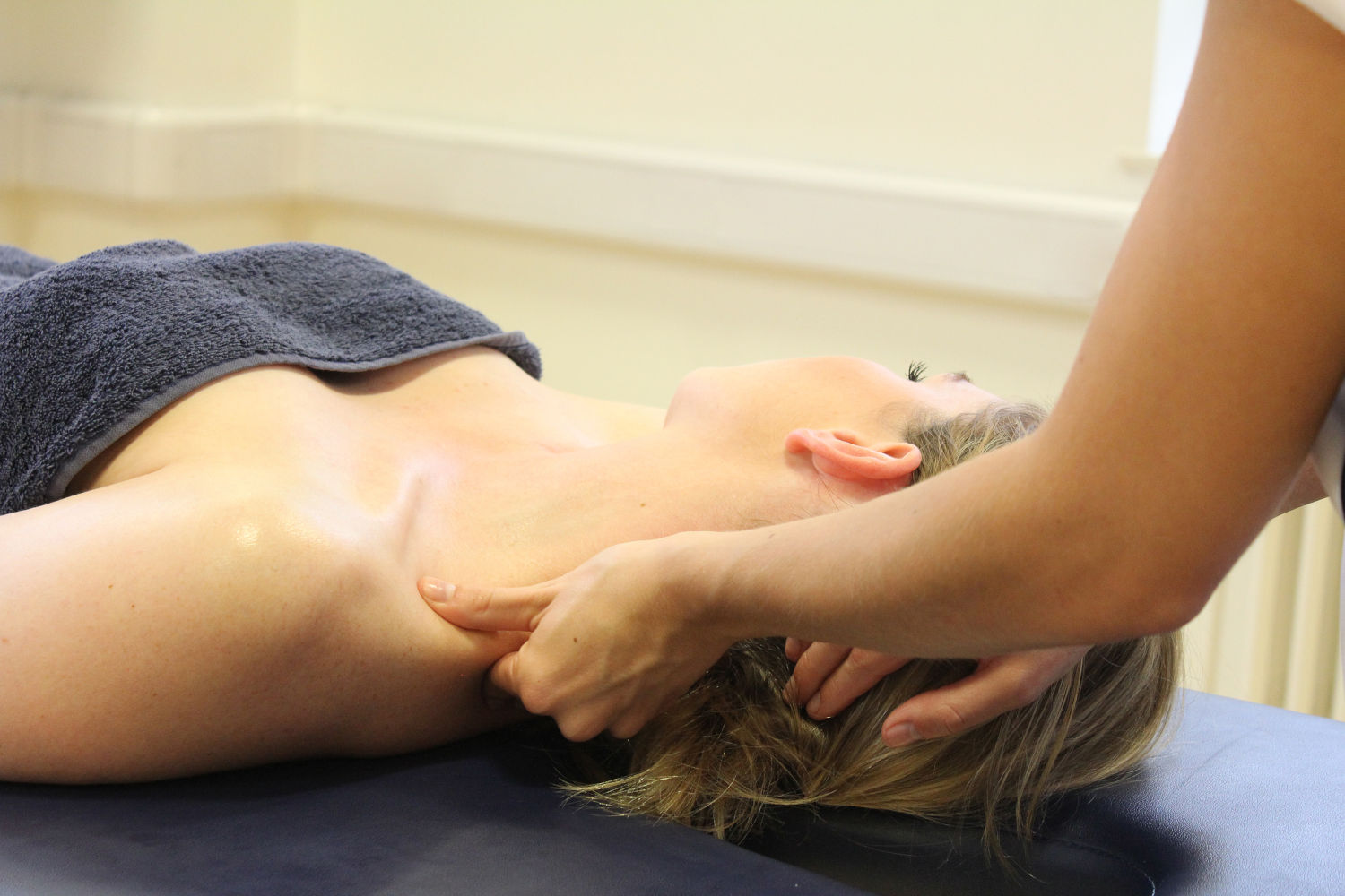 Physio therapist touching patient's shoulders.