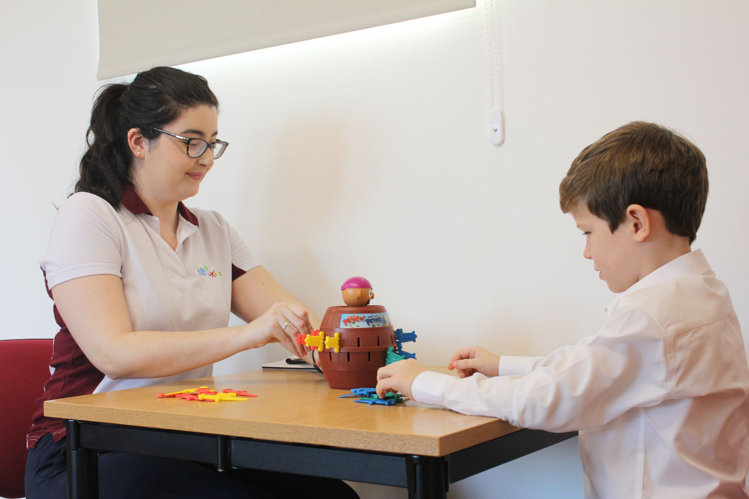 SLT for Kids therapist and young boy playing Pop-Up Pirate.