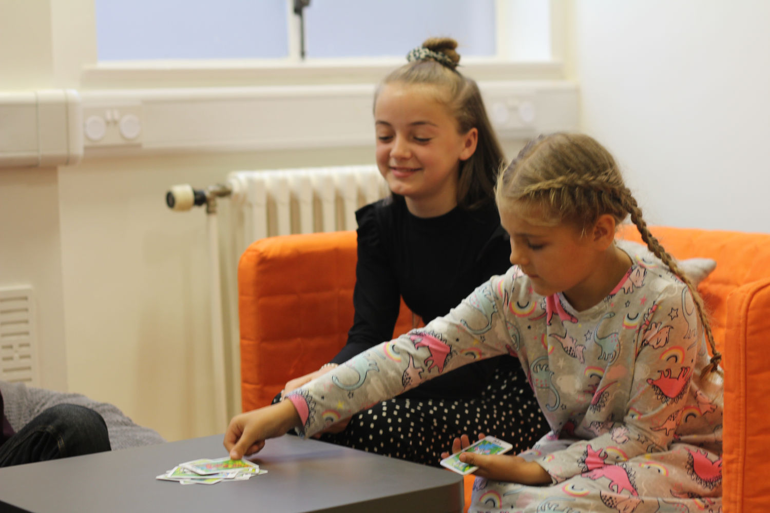 Little girl places a picture card at the top of a stack.