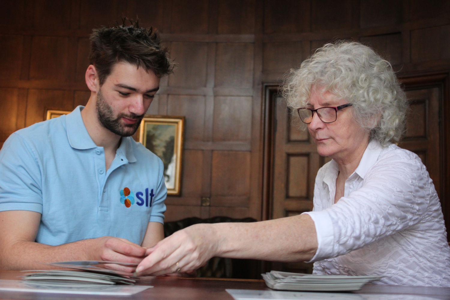 SLT therapist and patient smiling while working together.