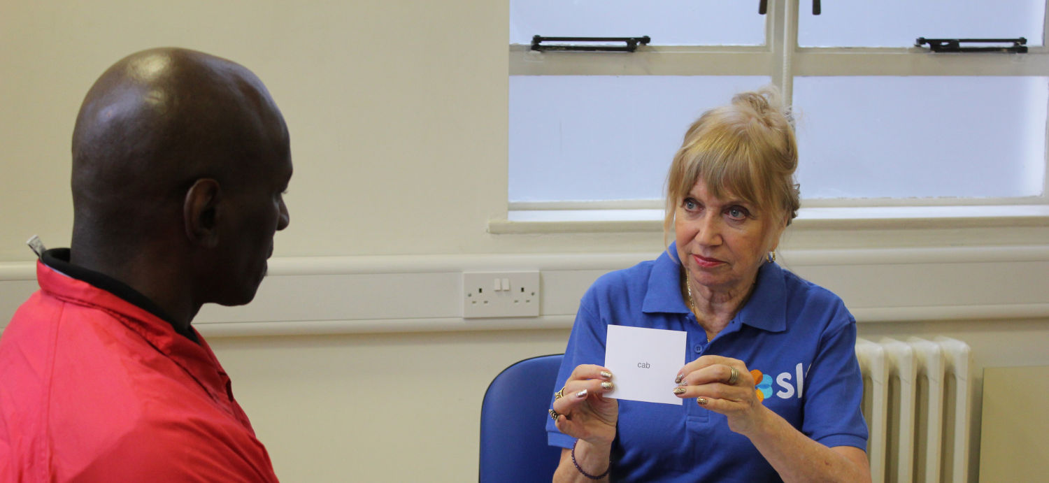 SLT therapist and patient using word cards.