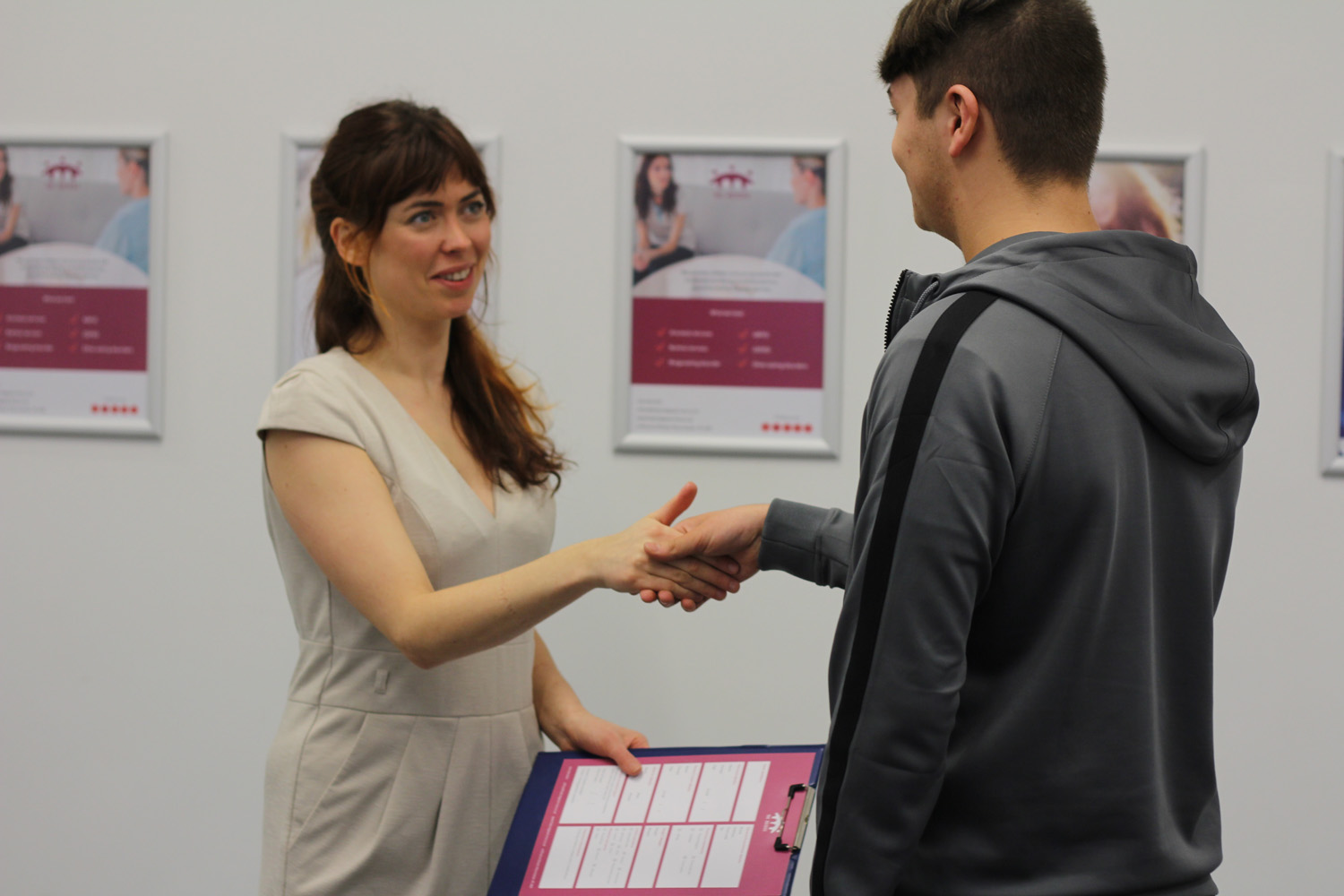 The Bridge therapist Lauren shaking hands with patient.