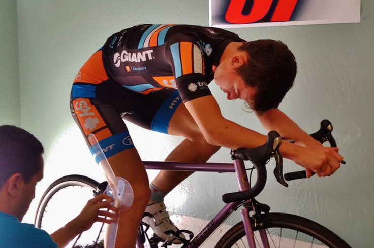 Cycling specialist measuring leg angles.