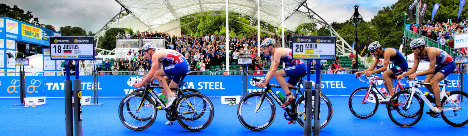 Professional triathletes at start line.