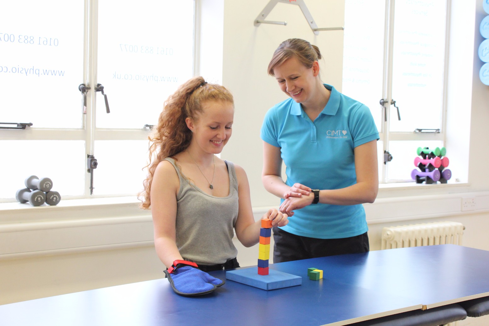 CIMT therapist working with young lady.